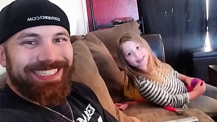 Adam Lind and daughter Aubree sitting on a couch