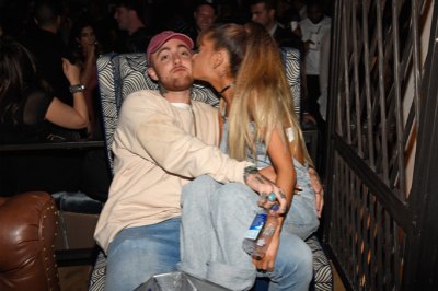 Mac Miller and Ariana Grande kissing at an event