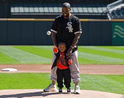kanye west helps saint west throw first pitch at white sox game