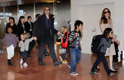 Brad Pitt and Angelina Jolie taking their kids through the airport