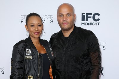 Mel B wearing a leather jacket with Stephen Belafonte, also wearing black