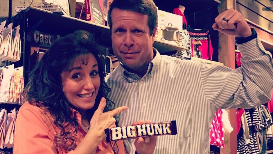 Michelle Duggar Points To Flexing Jim Bob Duggar While Holding "Big Hunk" Candy Bar