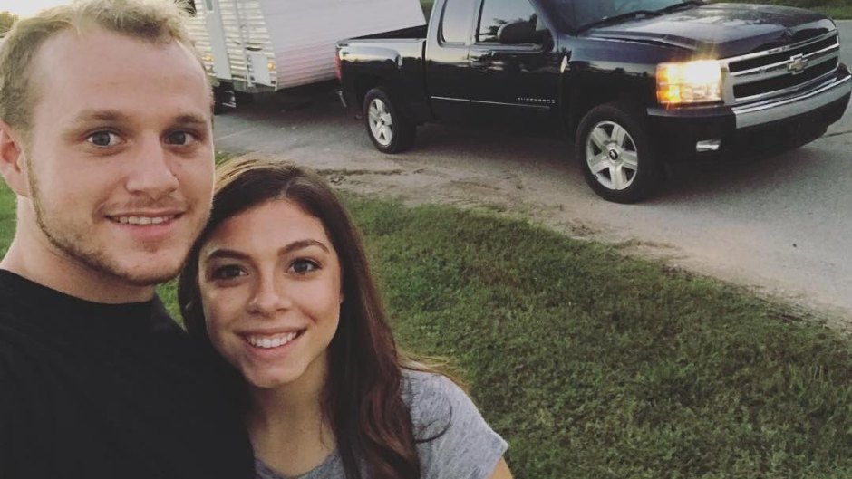 Josiah Duggar And Lauren Swanson Smiling In Front Of Truck And Trailer
