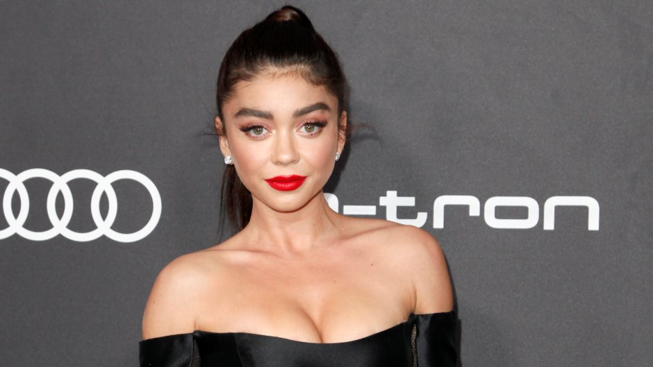 Sarah Hyland wearing black dress with red lipstick at an event