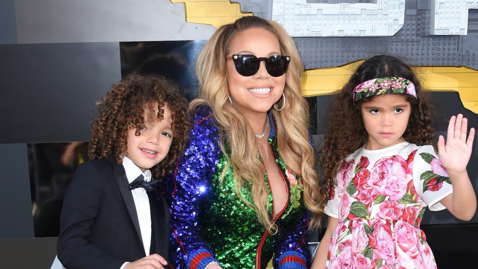 Mariah Carey with her twins at an event, she is wearing sunglasses