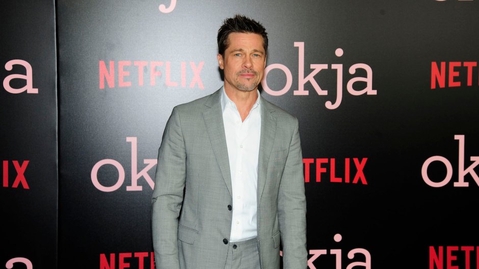 Brad Pitt wearing a gray suit at an event