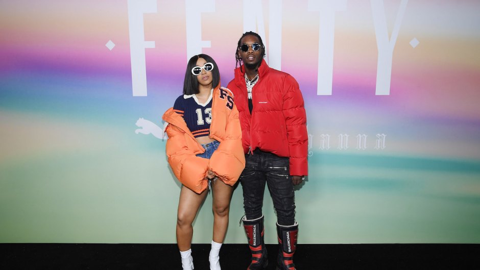 Cardi B in orange coat and Offset in red jacket at an event