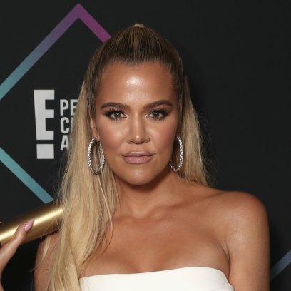 Khloe Kardashian wearing white and looking tan at event