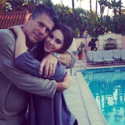 McKayla Maroney with her dad by a pool