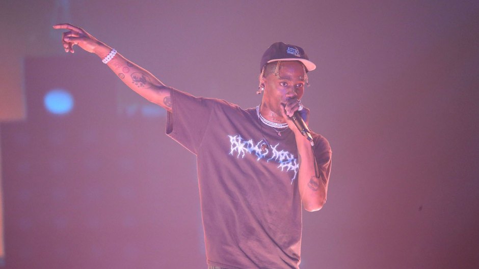 Travis Scott performing on stage in a t-shirt