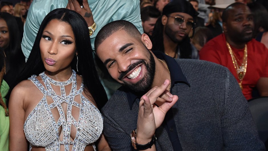 Nicki Minaj wearing a silver outfit with Drake