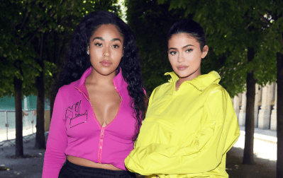 Jordyn Woods wearing pink and Kylie Jenner wearing yellow posing together