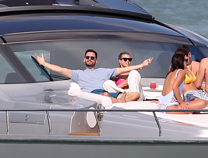 EXCLUSIVE: Model Sofia Richie wears a hot pink bikini top as she relaxes on a yacht with boyfriend Scott Disick in Miami at the miami yacht show