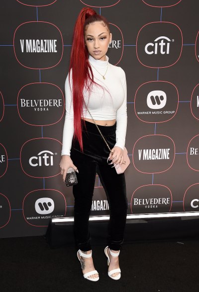 Danielle Bregoli at an event in a white shirt, red hair and black pants