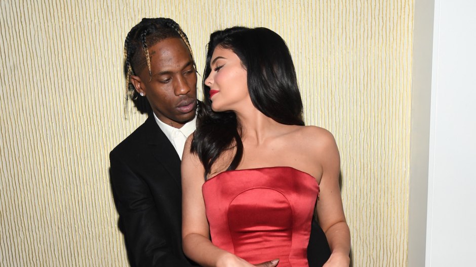 Kylie Jenner wearing a red dress with Travis Scott