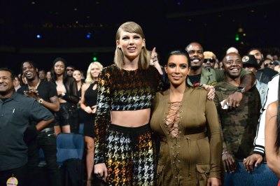 Taylor Swift smiling with Kim Kardashian 