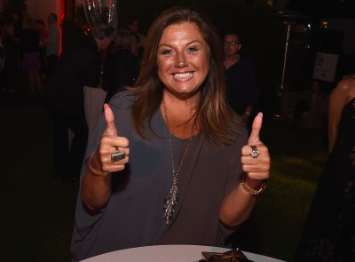abby lee miller looking happy at an event