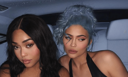 Kylie Jenner and Jordyn Woods posing in a car.