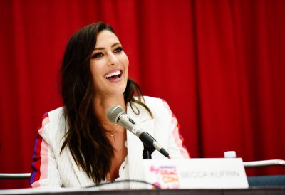 Becca Kufrin Wearing a White Suit on a Panel