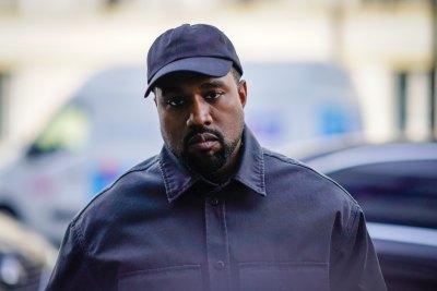 Kanye West Wearing a Black Outfit With a Hat