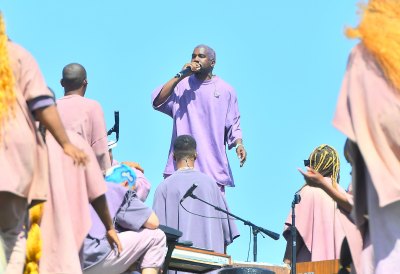 Kanye West Wearing a Purple Outfit At Sunday Service