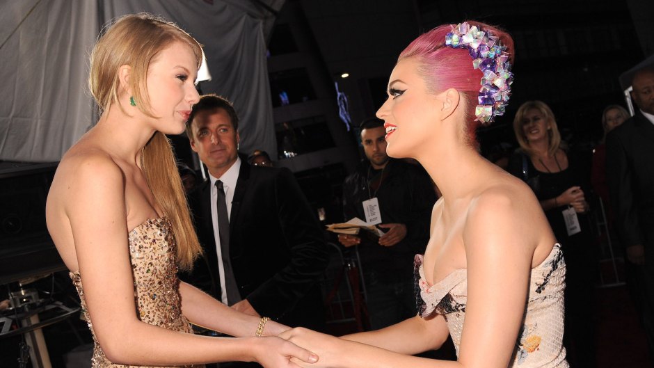 Taylor Swift in a Gold Dress with Katy Perry With Pink Hair Holding Hands