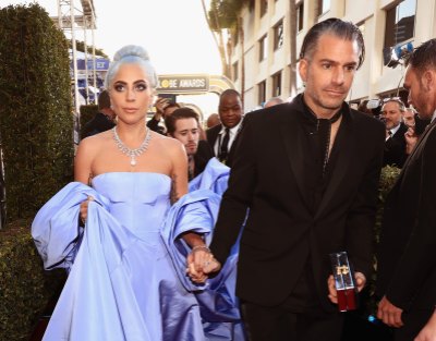 Lady Gaga Wearing a Purple Dress with Christian Carino in a Suit
