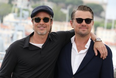 Leonardo DiCaprio Wearing Sunglasses and a Black Suit with Brad Pitt in Sunglasses