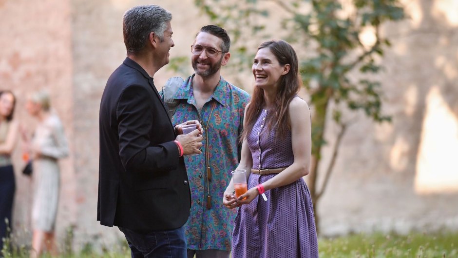 Amanda Knox Speaking With Some People and Sipping a Drink in Italy