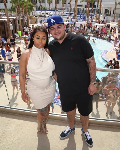 Blac Chyna Wearing a White Shirt with Rob Kardashian Wearing Black With a Blue Hat