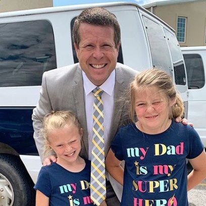 Jim Bob Duggar in Grey Suit Leans Down to Pose With Daughters Josie and Jordyn-Grace In Shirts That Say 'My Dad Is My Super Hero'