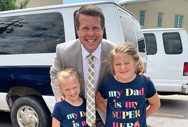 Jim Bob Duggar in Grey Suit Leans Down to Pose With Daughters Josie and Jordyn-Grace In Shirts That Say 'My Dad Is My Super Hero'