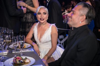 Lady Gaga Smiling In a white dress with Ex-Fiance Christian Carino in a Suit