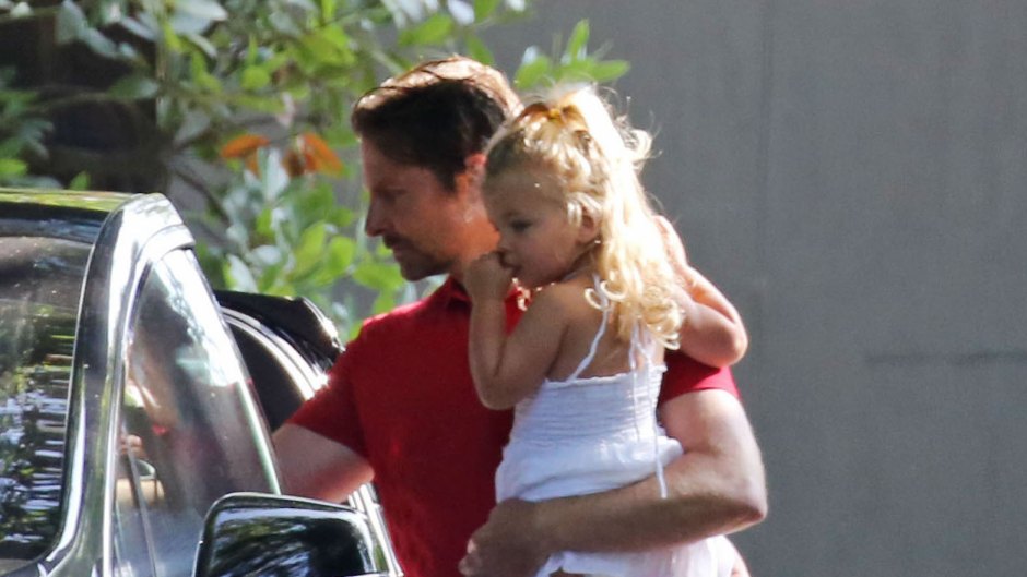 Bradley Cooper Carrying His Daughter Around Wearing a Red Shirt