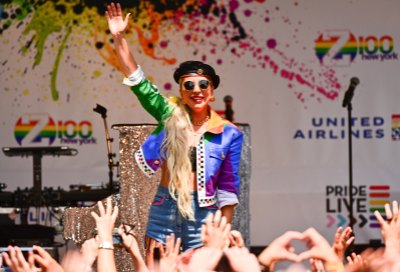 Lady Gaga Wearing Rainbow Outfit Waving to the Crowd of People