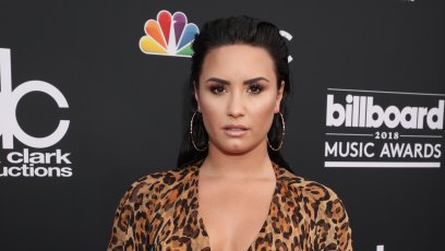 Demi Lovato Slicked Back Hair Cheetah Print Dress and Hoop Earrings Social Media Break