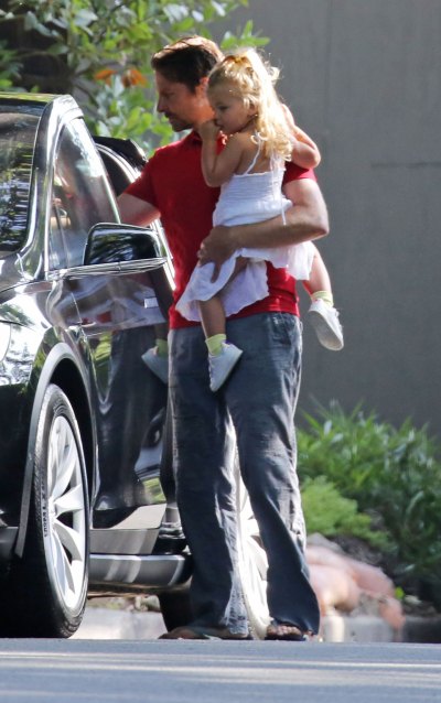 Bradley Cooper Holding His Daughter Wearing a Red Shirt