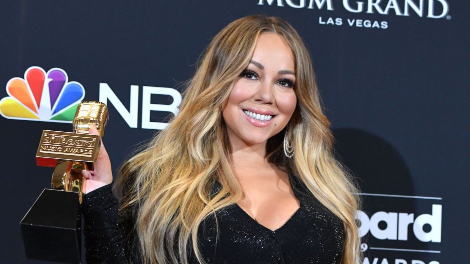 Mariah Carey Holding an Award Wearing a Black Dress