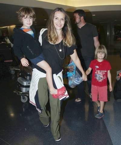 Brooke Mueller Wearing a Black Shirt Holding Her Son's Hands