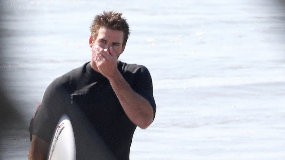 Liam Hemsworth Wearing a Wet Suit Surfing in Australia