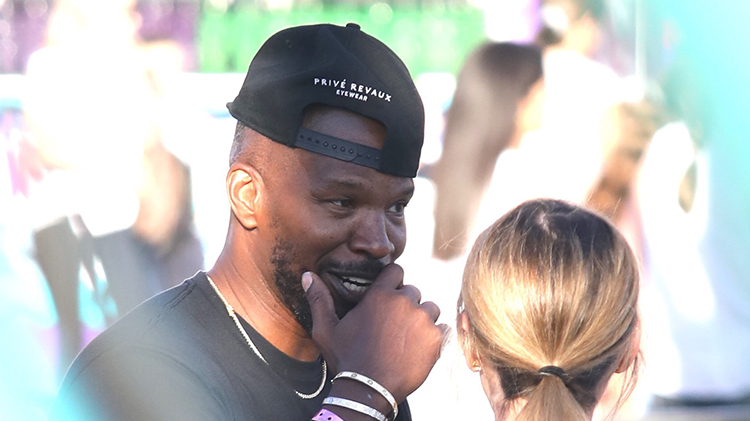 jamie foxx wears black t shirt and black hat while spending time with his family at the malibu chili cook off festival