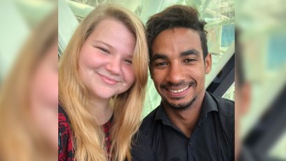 90 day fiance star nicole nafziger smiles and poses for a selfie with her fiance azan tefou nicole is wearing a red and black rose print dress and azan is wearing a black button up shirt 90 day fiance nicole azan journey still together