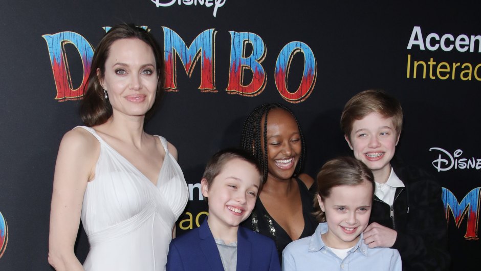 Angelina Jolie Wearing a White Long Dress With Some of Her Kids