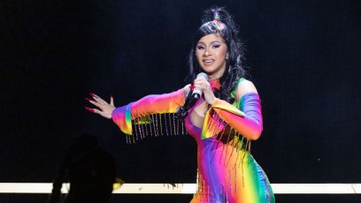 Cardi B on Stage Wearing a Rainbow Outfit