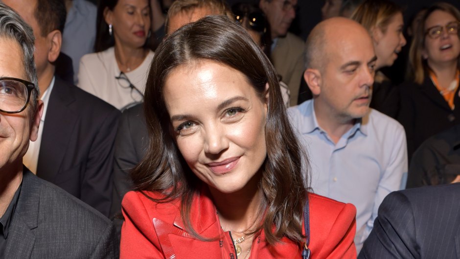 Katie Holmes Wearing a Red Dress During a Fashion Show