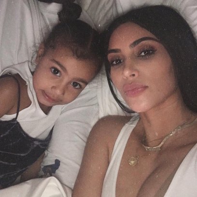 Kim Kardashian Wearing a White Shirt With north West in Bed