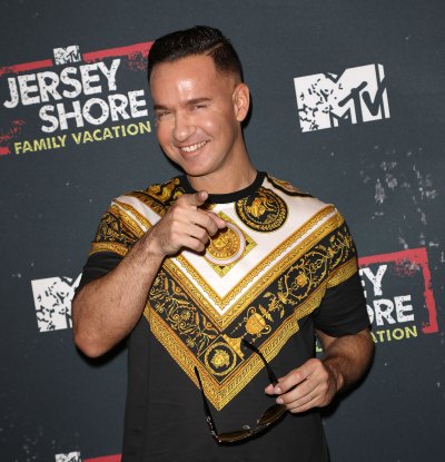 Mike the situation Pointing at the Camera Wearing a Yellow and Black Shirt