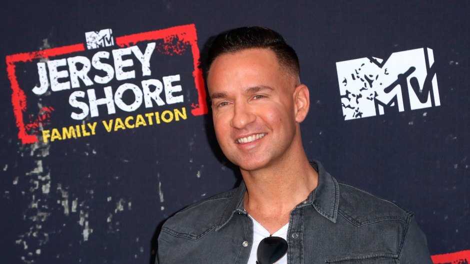 Mike the situation Wearing a Jean Shirt and Smiling