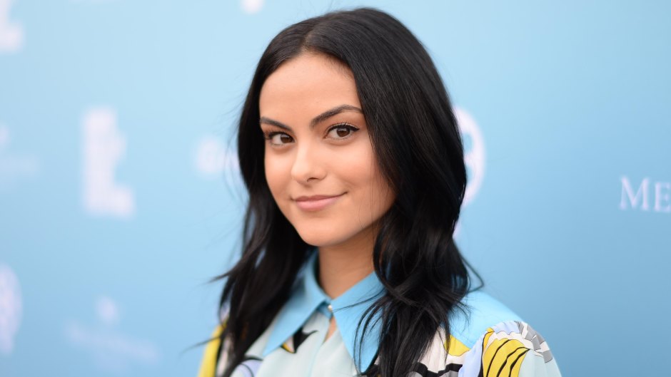 camila-mendes-at-rising-star-showcase-2018 in front of blue background
