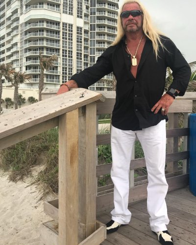duane dog chapman standing on a deck on the beach